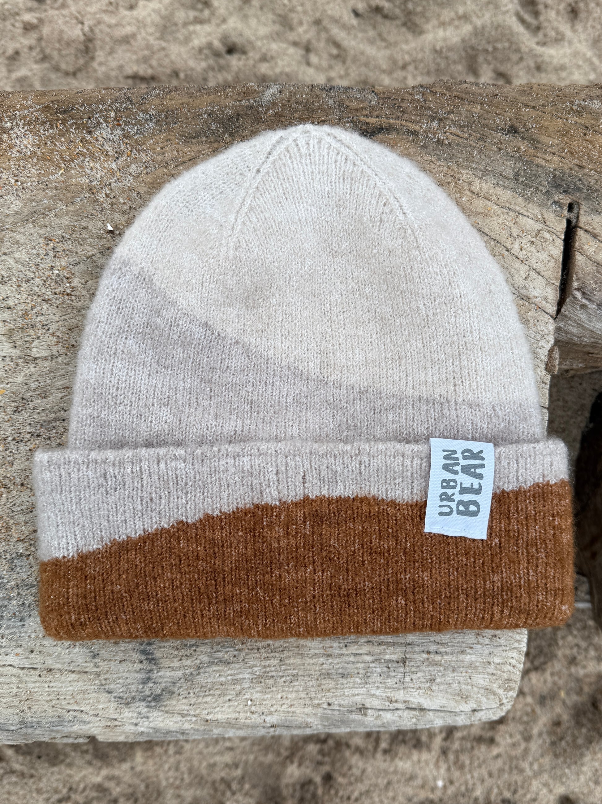 Chunky knit over side beanie in natural colours.