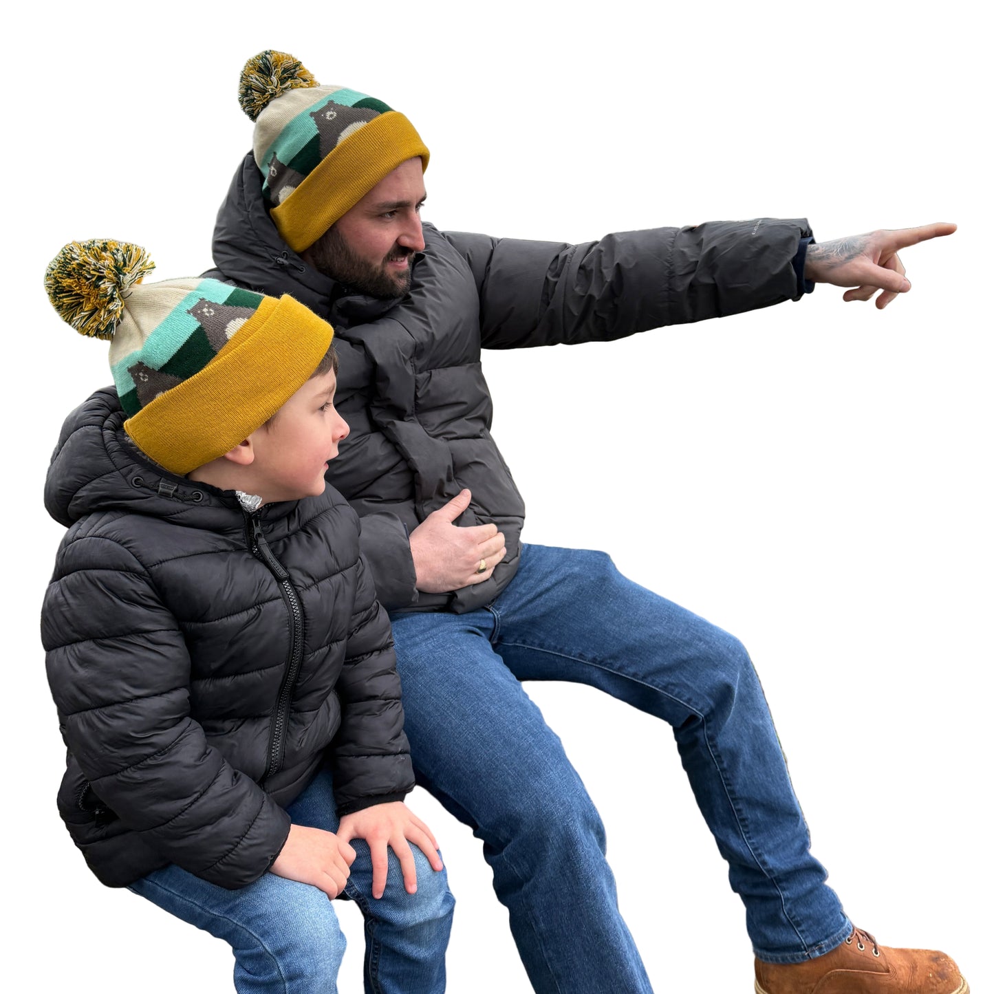 Dad and son in winter wearing matching bear bobble hats