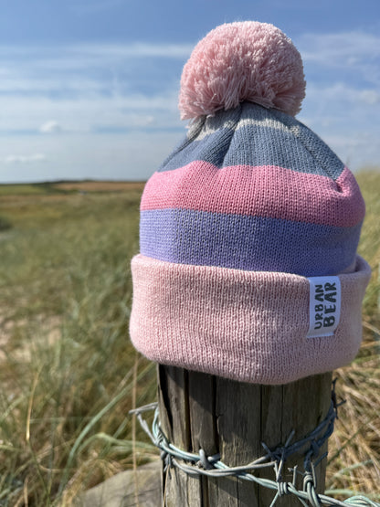 Pastel colour hat on a post with a Pom Pom 