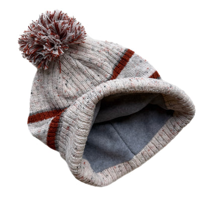 Knitted beanie with a pom-pom on a white background
